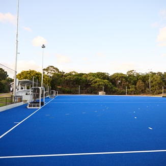 A side on photo of one of the hockey goals and surroundng astroturf located on the astroturf at Arena Joondalup