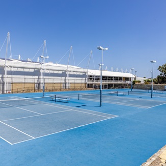 A photo of multiple outdoor tennis courts side by side at Arena Joondalup