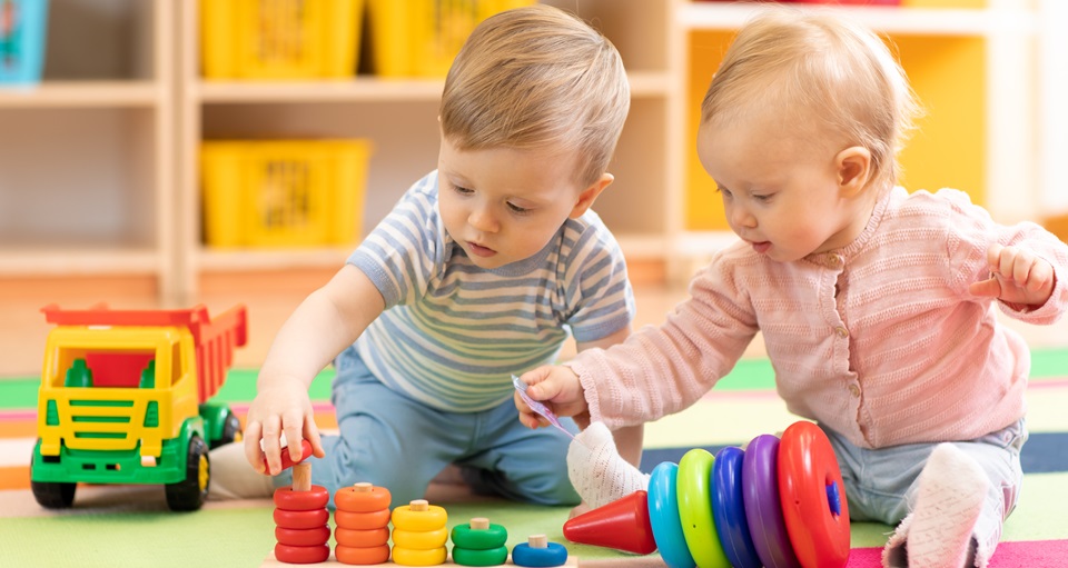 Two toddlers playing together in a crèche