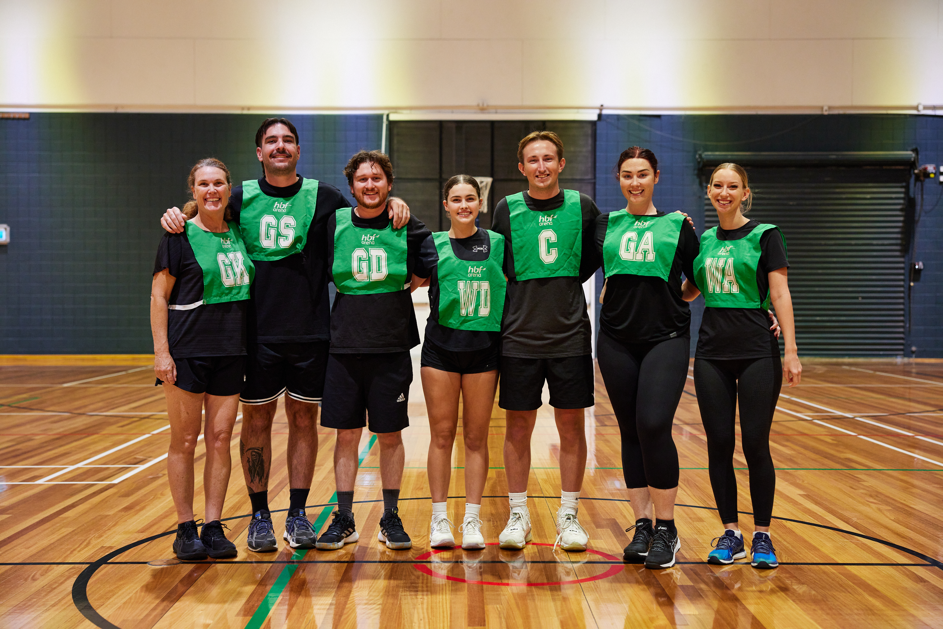 Mixed netball players talking tactics