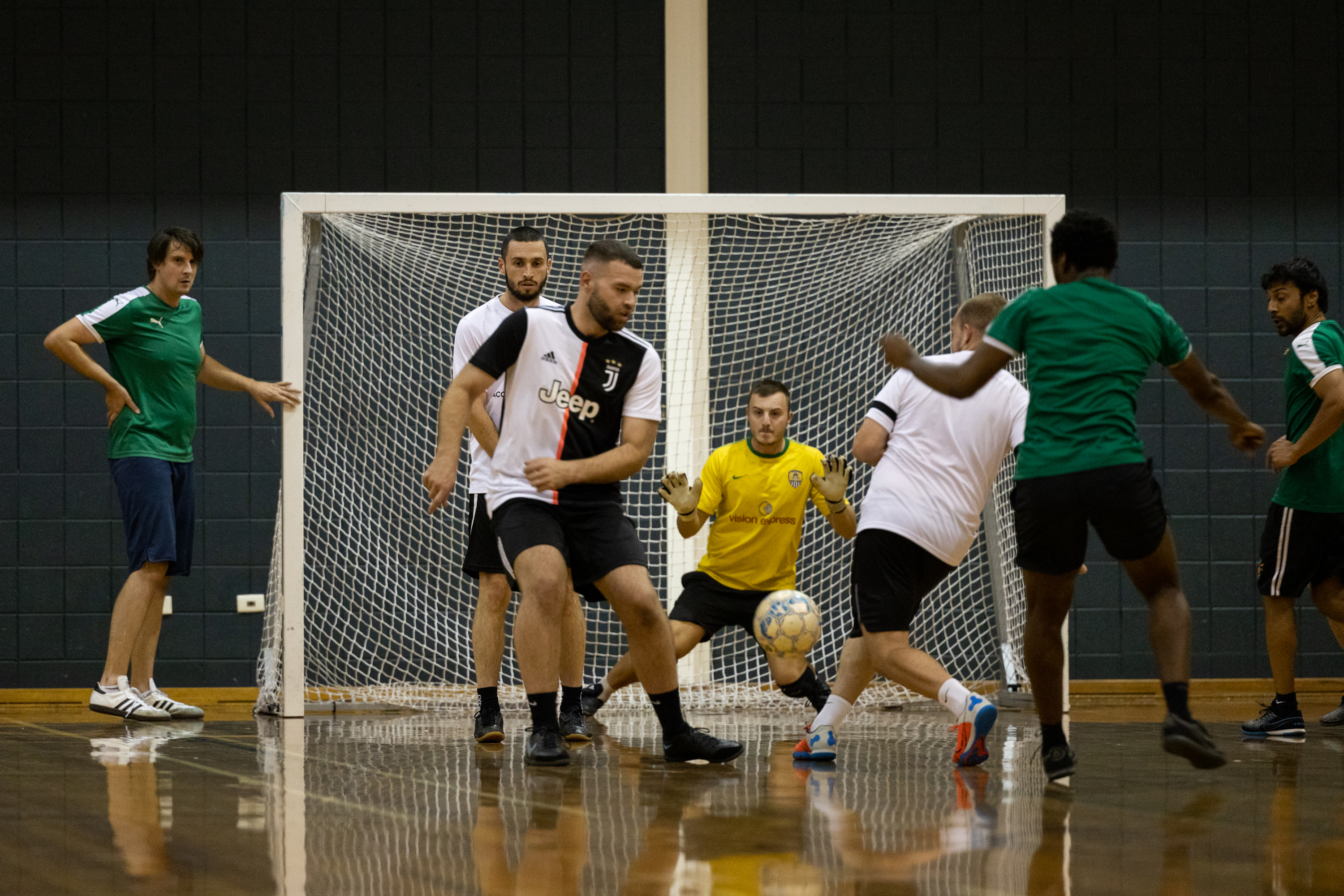 Goalie defending the goal during a men's futsal game