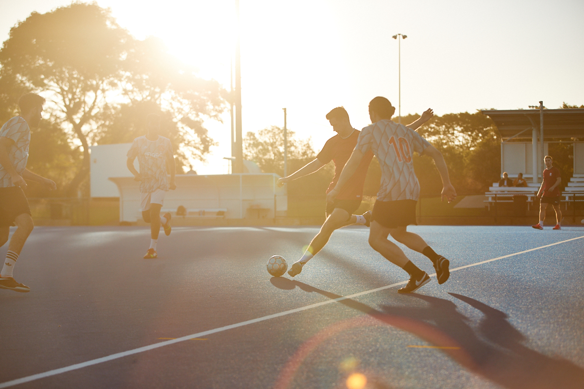 Soccer players contesting the ball during an outdoor turf game