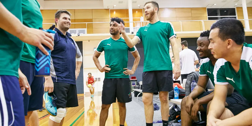 Men's futsal team talking tactics