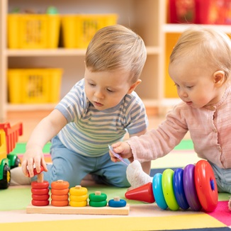 Two toddlers playing together in a crèche