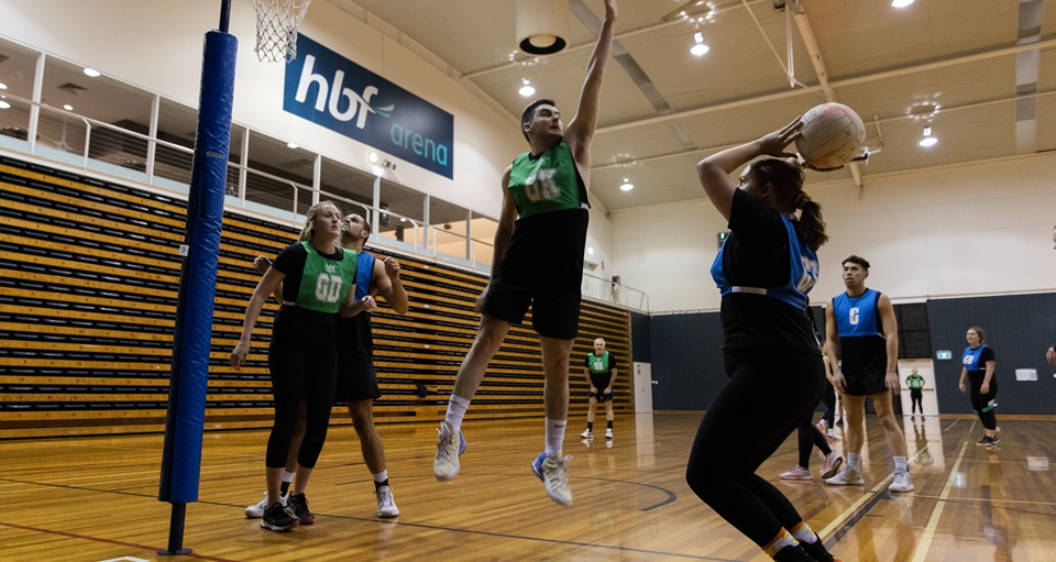 Player defending a goal shooter during a mixed netball game