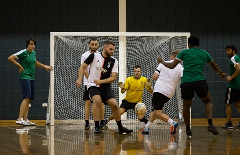 Goalie defending the goal during a men's futsal game